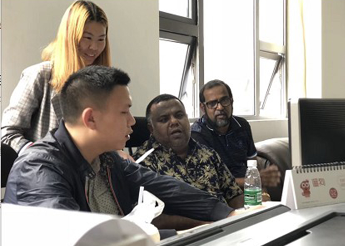Business meeting between Western buyer and Chinese factory representative